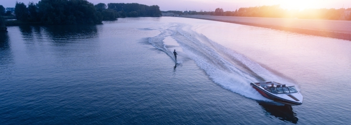 water skiing on lake behind boat